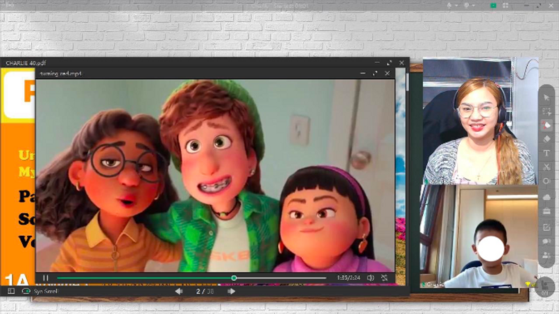 Teacher Jadey showing a slide deck and a video in class